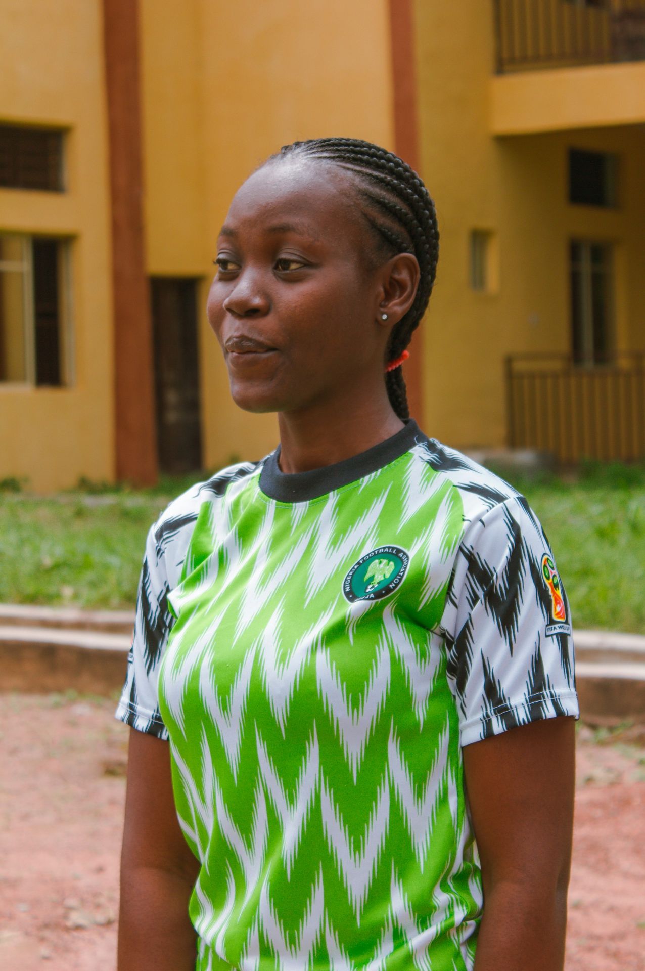boy in green and white adidas soccer jersey